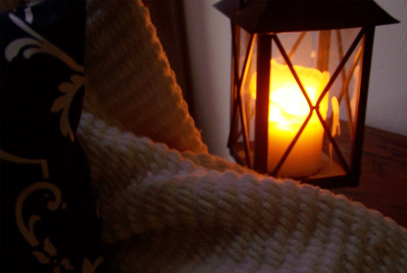candles and a blanket on the balcony
