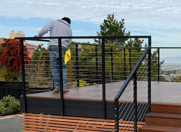 One of our pros putting finishing touches on a cable railing system